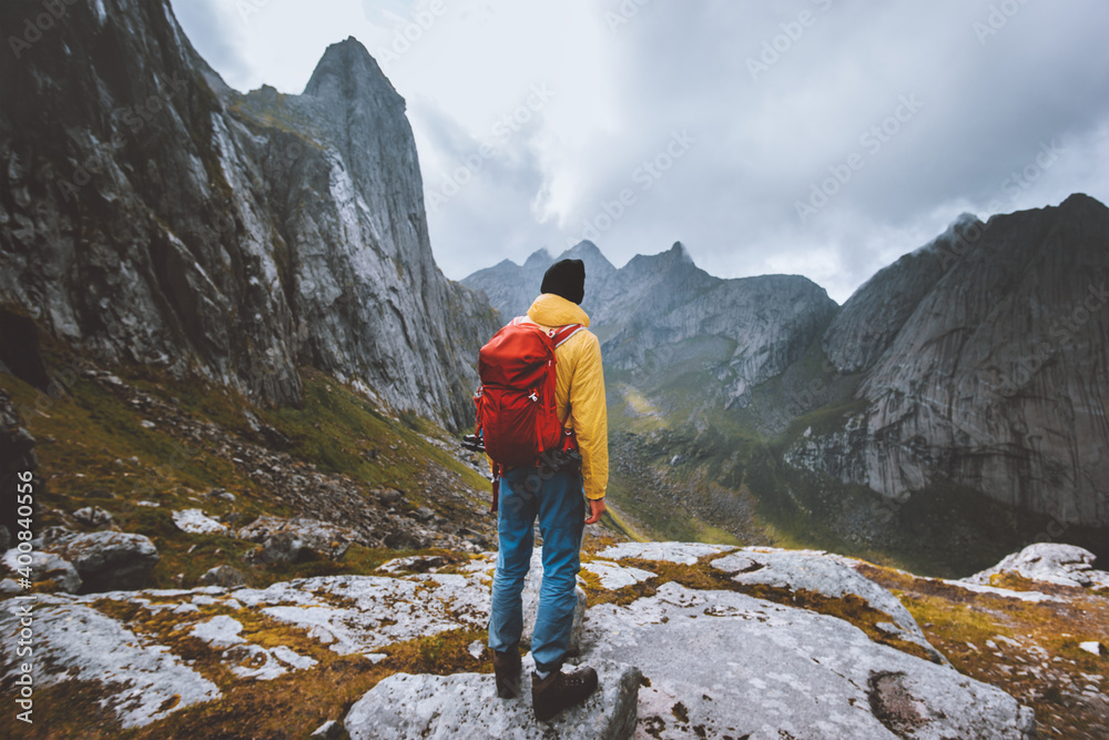 Man backpacker enjoying mountains landscape travel hike alone in Norway outdoor adventure active healthy lifestyle weekend leisure tour - obrazy, fototapety, plakaty 