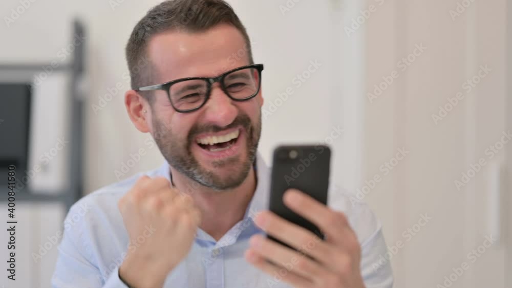 Portrait of Middle Aged Man Excited by Success on Smartphone Portrait of Middle Aged Man Excited by Success on Smartphone