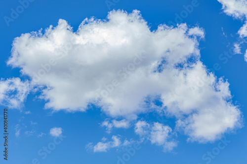 background of white fluffy clouds on a bright blue sky
