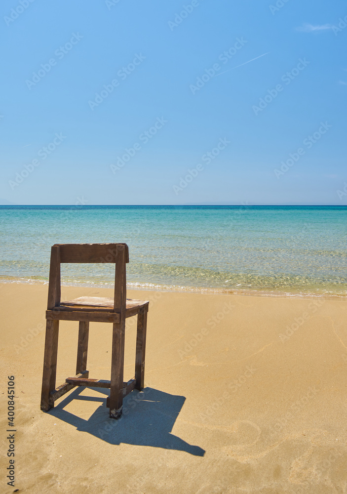 Lonely Old wooden chair on beach Lonely Old wooden chair on beach