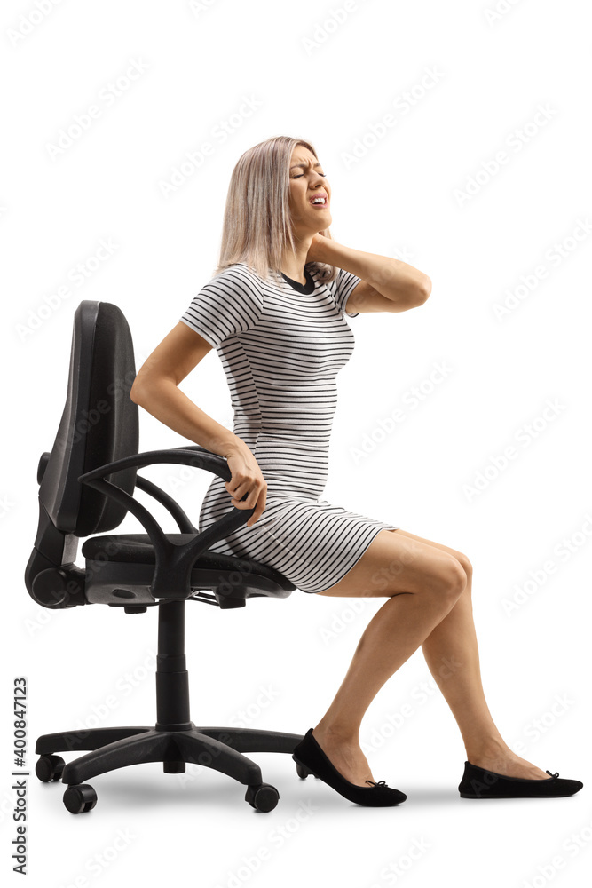 Young woman suffering neck pain and sitting in an office chair Young woman suffering neck pain and sitting in an office chair