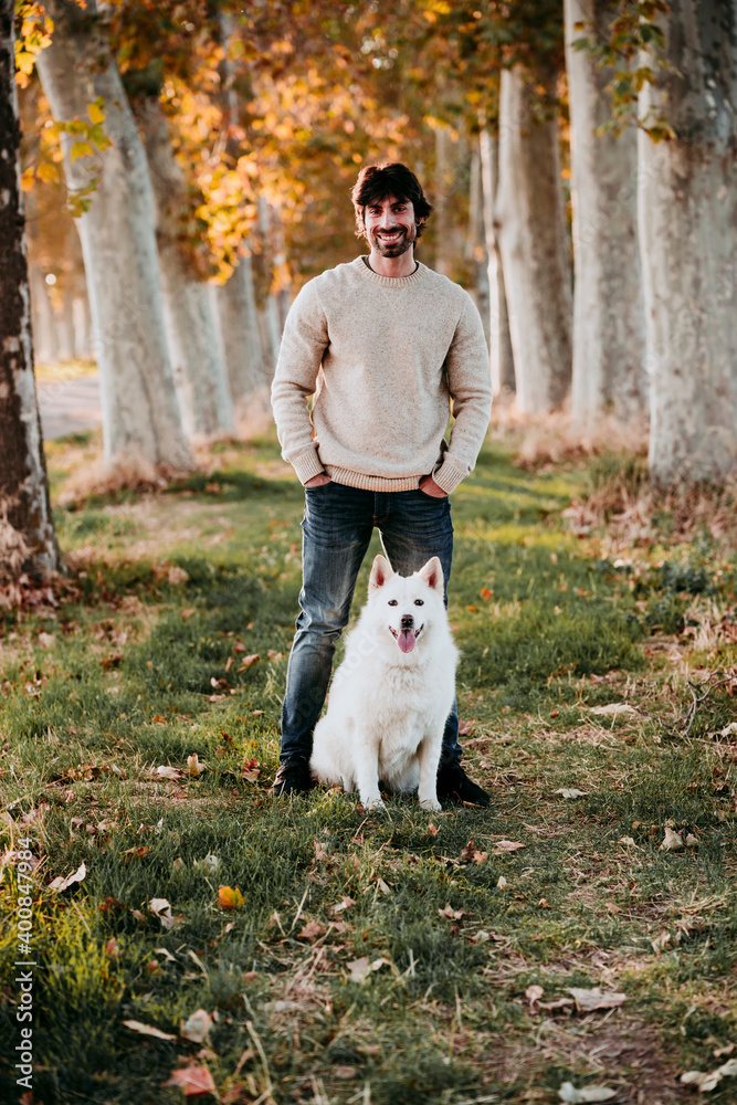 Man standing with dog at forest Man standing with dog at forest