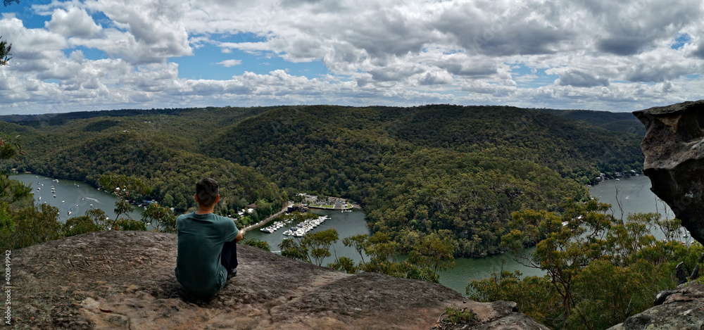 Beautiful panoramic view of a winding river with mountains, valleys and blue sky with white clouds, Berowra Heights, Berowra Valley National Park, Sydney, New South Wales, Australia
