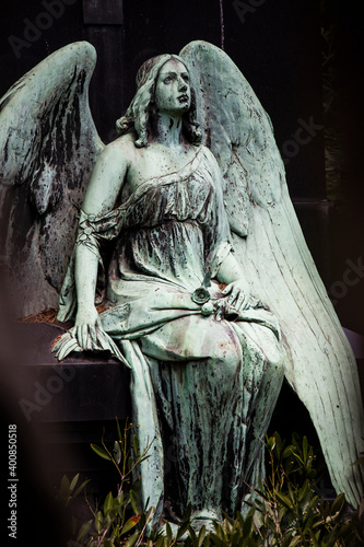 Weathered statue of sitting angel
