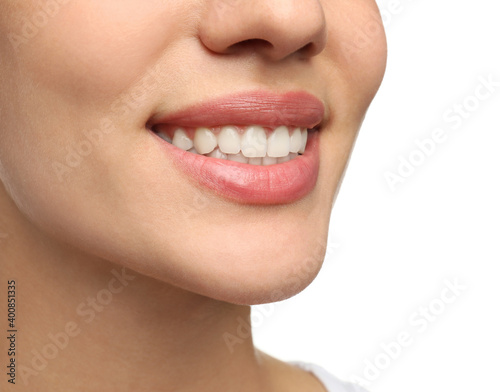 Woman with healthy teeth and beautiful smile on white background, closeup. Cosmetic dentistry