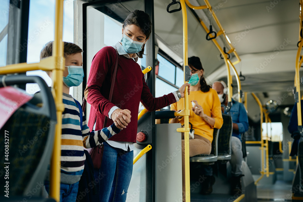 custom made wallpaper toronto digitalHappy mother and son wearing protective face masks while getting into public bus.