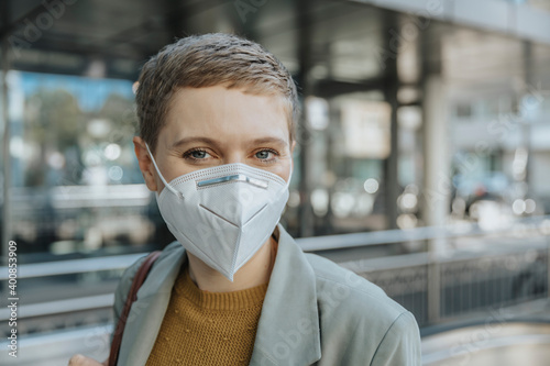 Woman wearing protective face mask standing in city
