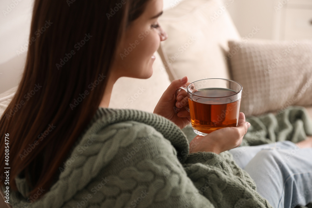 custom made wallpaper toronto digitalWoman covered with warm green plaid enjoying hot tea at home