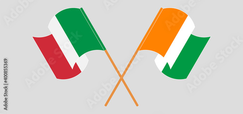 Crossed and waving flags of Italy and Republic of Ivory Coast