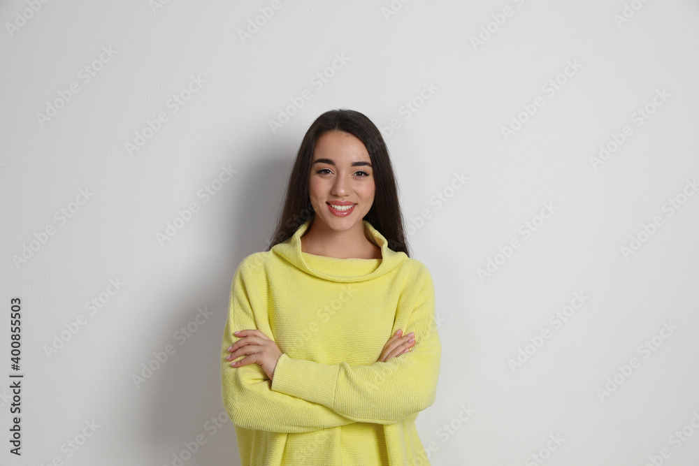 Beautiful young woman wearing yellow warm sweater on white background Beautiful young woman wearing yellow warm sweater on white background