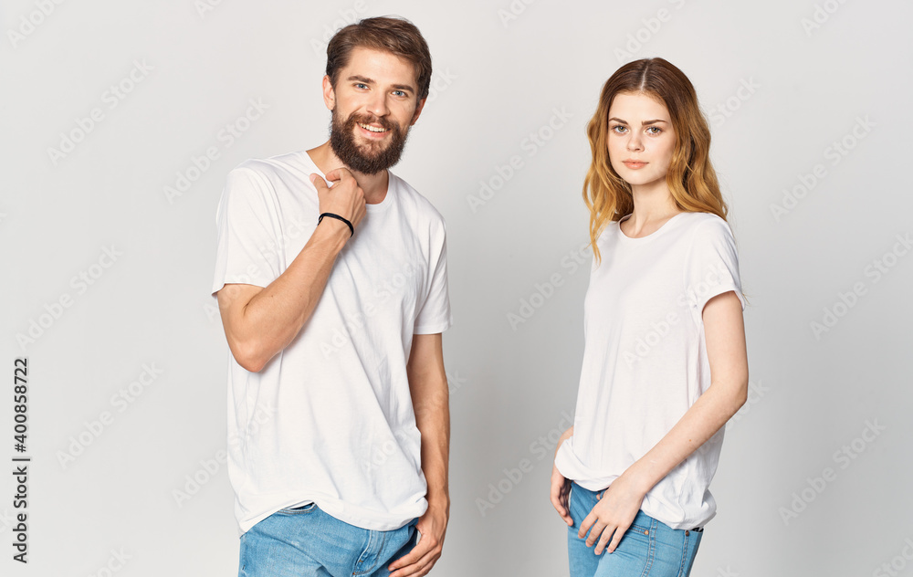 A man and a woman in jeans and a T-shirt are gesturing with their hands fun emotions Copy Space A man and a woman in jeans and a T-shirt are gesturing with their hands fun emotions Copy Space