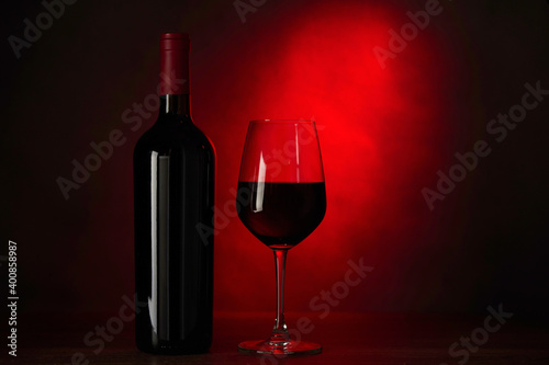 Glass red wine, bottle