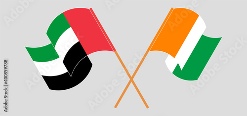 Crossed and waving flags of the United Arab Emirates and Republic of Ivory Coast