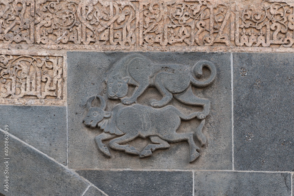 Combat of lion vs bull carved on the wall of Ulu Mosque in Diyarbakir, Turkey