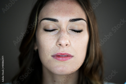 Young woman with eyes closed in studio