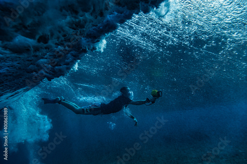 Man snorkeling while filming underwater at Maldives photo
