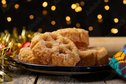 Fototapete Mexican fritter with sugar and cinnamon called bunuelo on wooden background