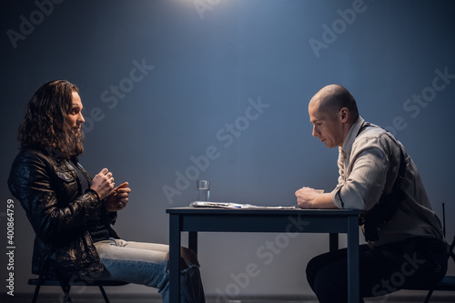 A police detective suspects a white man of committing a crime. Conducts an interrogation with the presentation of evidence in the interrogation room