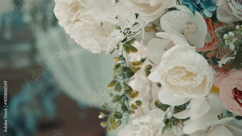 Closeup view of beautiful bouquet of flowers for wedding celebration is in light interior indoors.