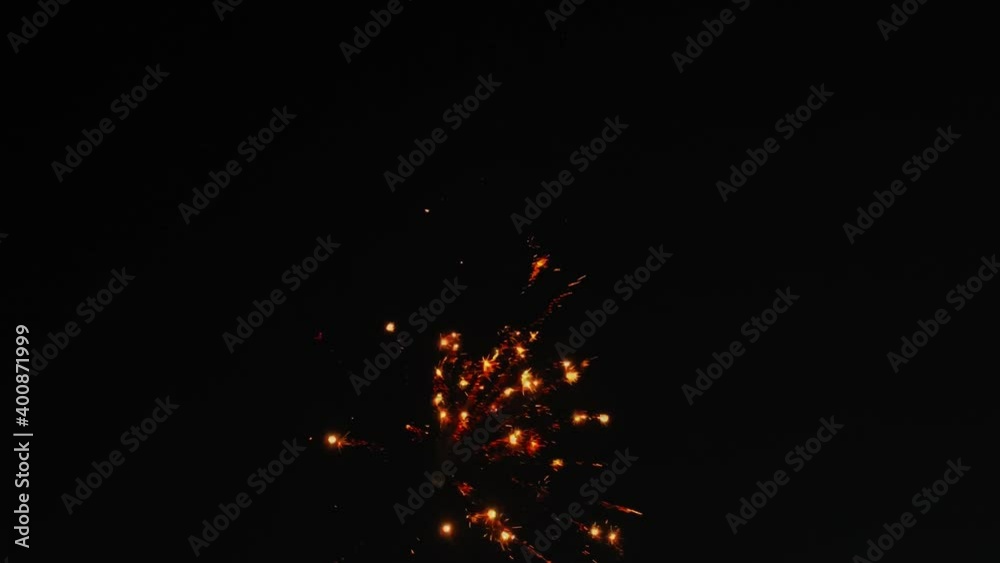 A small fireworks display lights up the night sky. A small fireworks display lights up the night sky.
