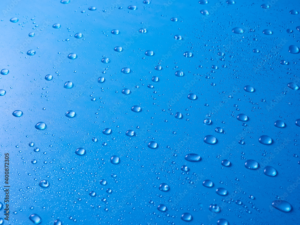 Random water drops on the blue PVC surface