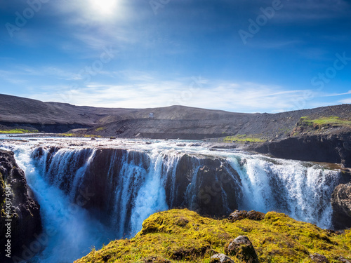 Sigoldufoss waterfall and surrounding hills photo