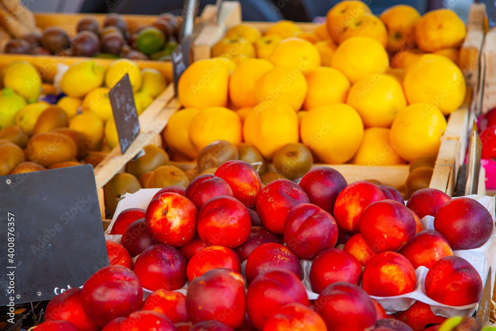Peaches and oranges at a stall in an agricultural market in Provence, France