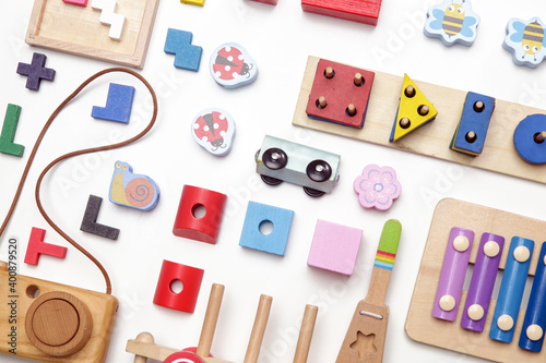 Colorful wooden children's eco friendly, sustainable toys, flat lay on white background