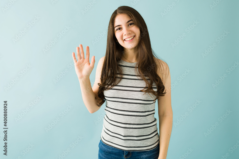 Portrait of a young woman smiling and saying hello Portrait of a young woman smiling and saying hello