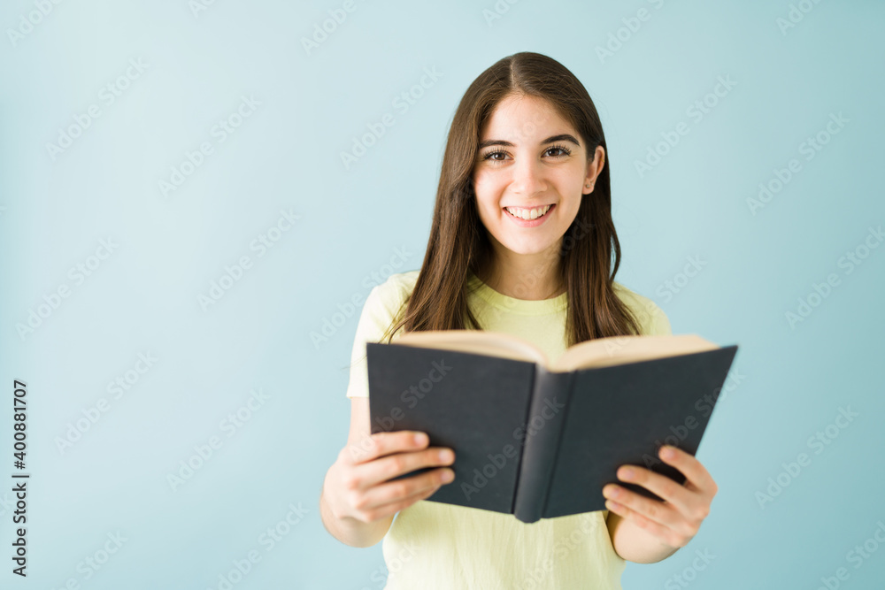 Portrait of a woman looking happy to be reading a book Portrait of a woman looking happy to be reading a book