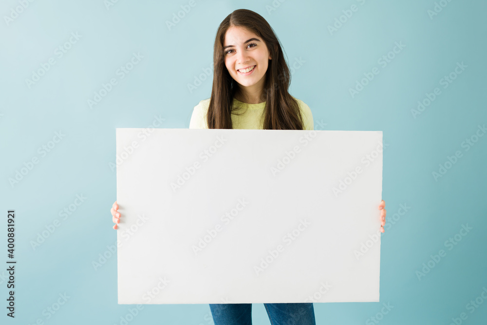 Good-looking woman holding a white blank sign Good-looking woman holding a white blank sign