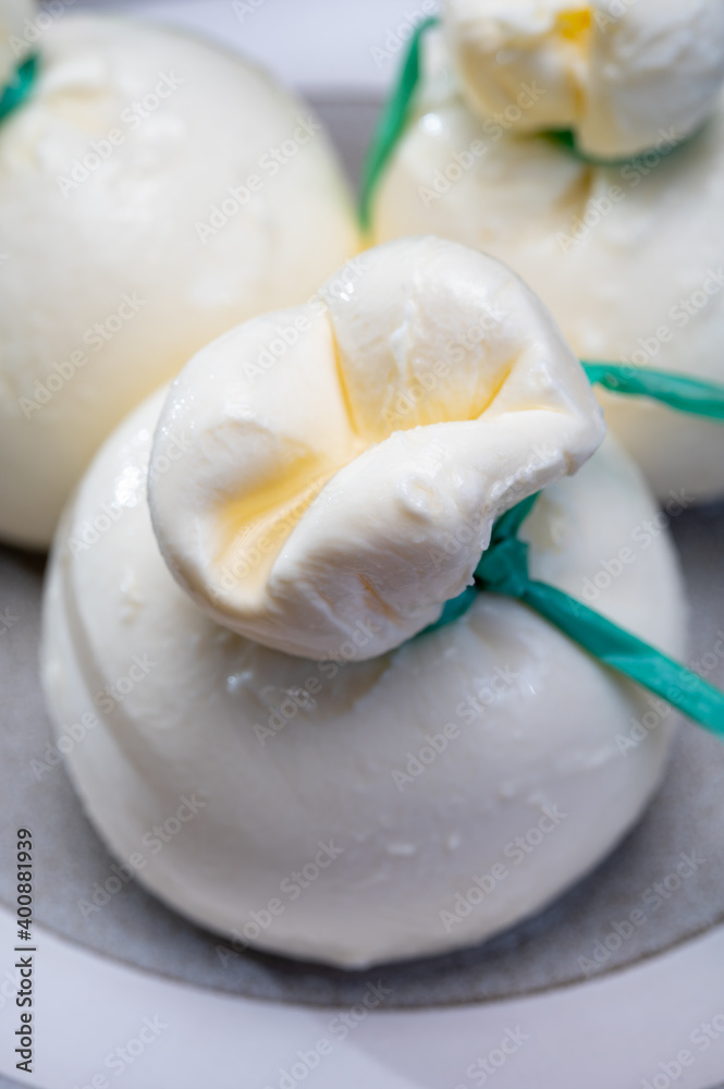 Cheese collection, fresh soft Italian cheese from Puglia, white balls of burrata or burratina cheese made from mozzarella and cream filling Cheese collection, fresh soft Italian cheese from Puglia, white balls of burrata or burratina cheese made from mozzarella and cream filling