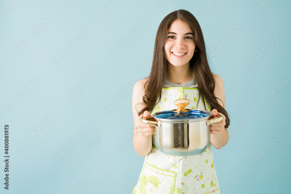 Female cook is happy to have finished cooking dinner Female cook is happy to have finished cooking dinner