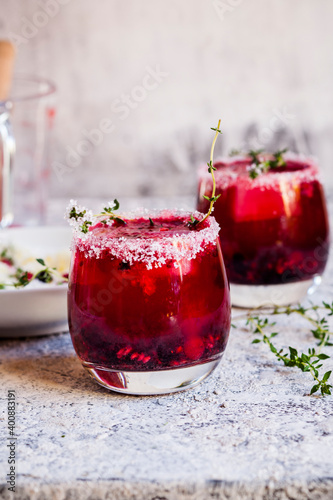 Wild berry thyme smash with wild berries, thyme, tequila, and sparkling water photo