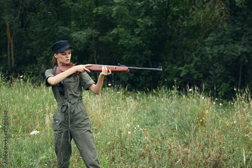 Woman Green overalls weapon in the hands of hunting fresh air fresh air 