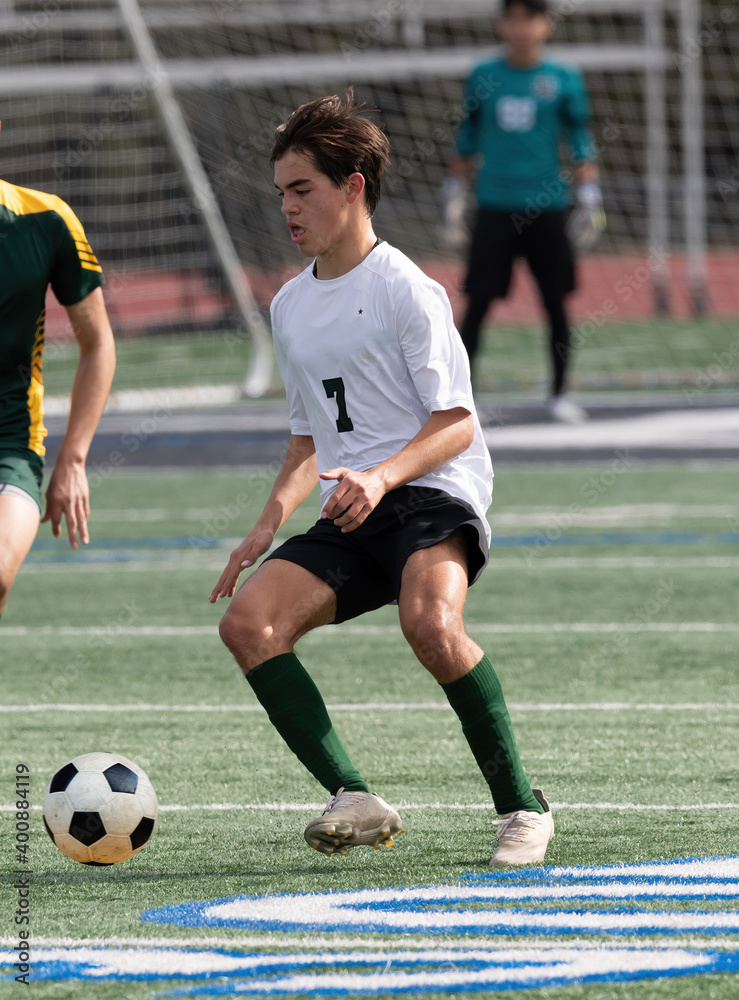 Athletic young boy playing in a competitive soccer game