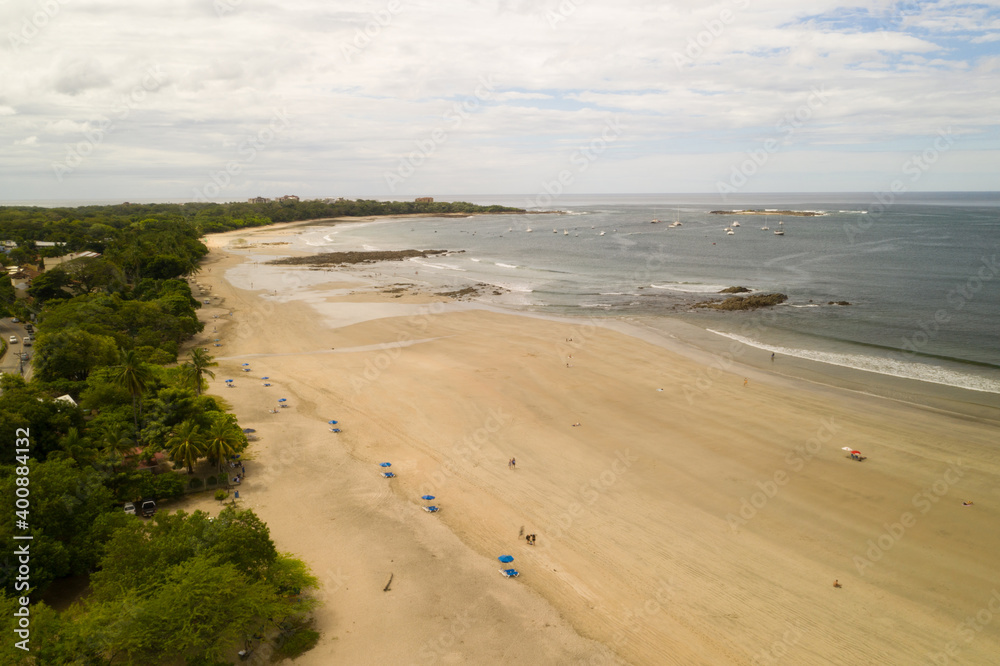 A aerial view of the beach in Tamarindo Costa Rica taken from a drone.