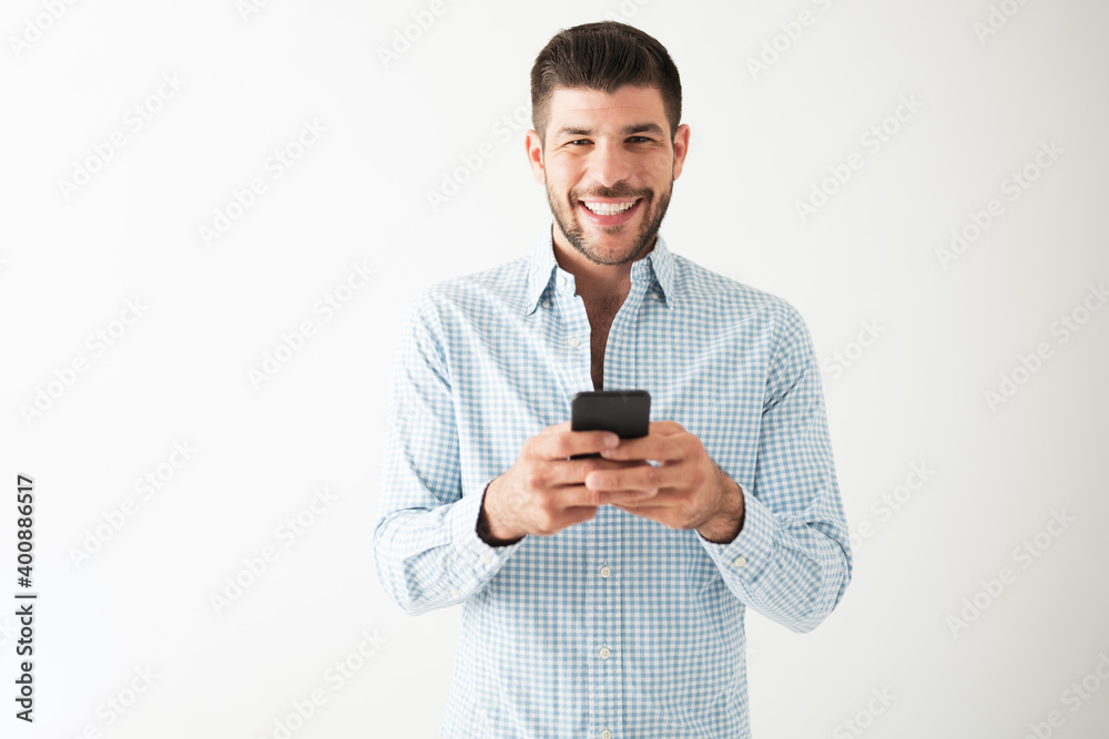Young guy that just received happy news on his cellphone Young guy that just received happy news on his cellphone