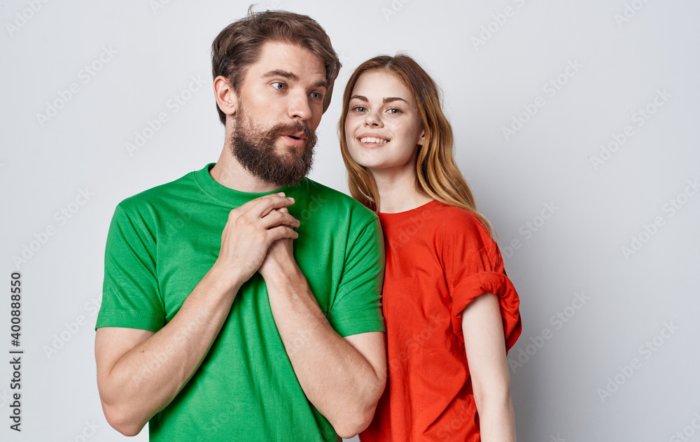 young couple in multicolored t-shirts emotions studio friendship young couple in multicolored t-shirts emotions studio friendship