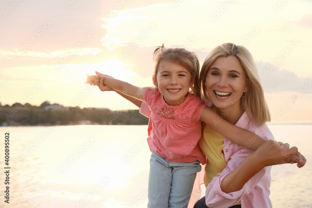 Happy mother and her child on beach. Spending time in nature Happy mother and her child on beach. Spending time in nature