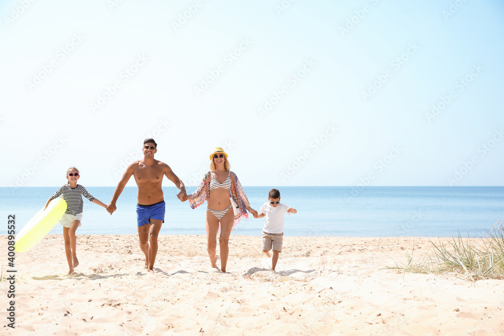 Family with inflatable ring at beach on sunny day
