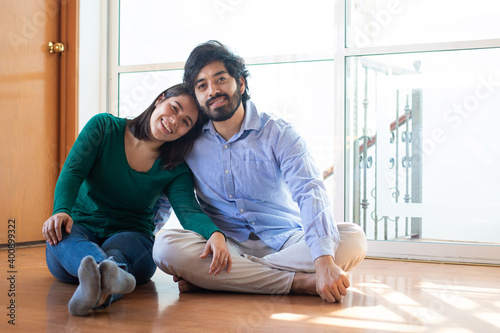 Young recently wedded couple in their empty new apartment