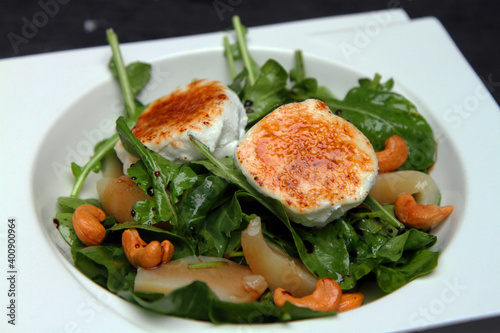 Grilled and caramelized goat cheese served with arugula salad, sauteed pears and cashew nuts