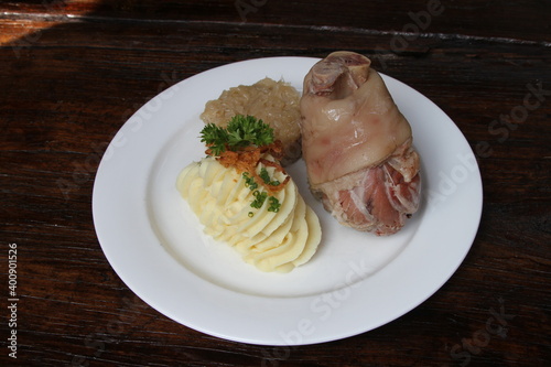Eisbein, German pickled and cured ham hock served with potato mash and sauerkraut