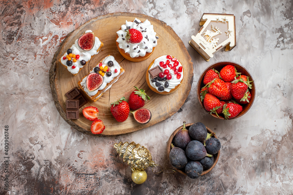 top view delicious cakes with fresh fruits on light background christmas cake dessert biscuit color top view delicious cakes with fresh fruits on light background christmas cake dessert biscuit color