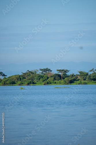 Magdalena River in Colombia, with blue sky and trees on the river bank.