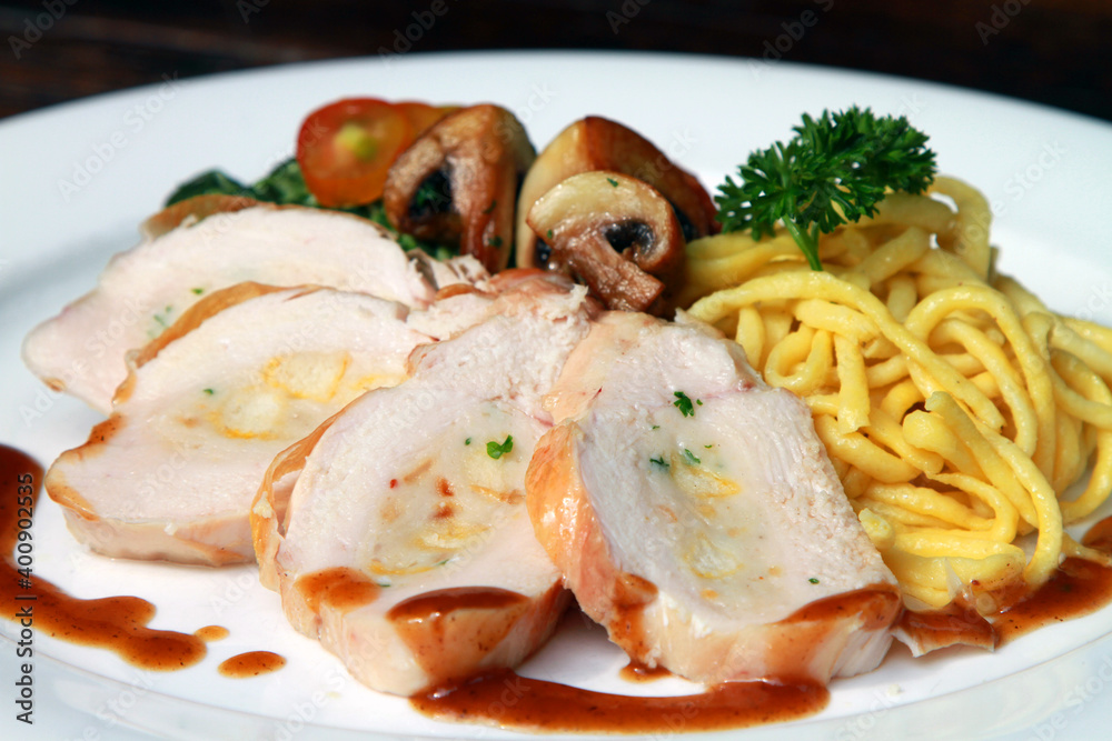 Chicken breast with spaetzle and mushrooms, served with Calvados sauce Chicken breast with spaetzle and mushrooms, served with Calvados sauce