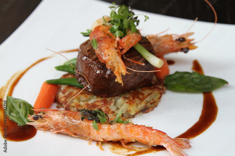 Surf and Turf, beef fillet steak with roesti, garden vegetables and prawns Surf and Turf, beef fillet steak with roesti, garden vegetables and prawns