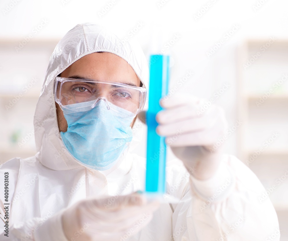 Young chemist student working in lab on chemicals Young chemist student working in lab on chemicals