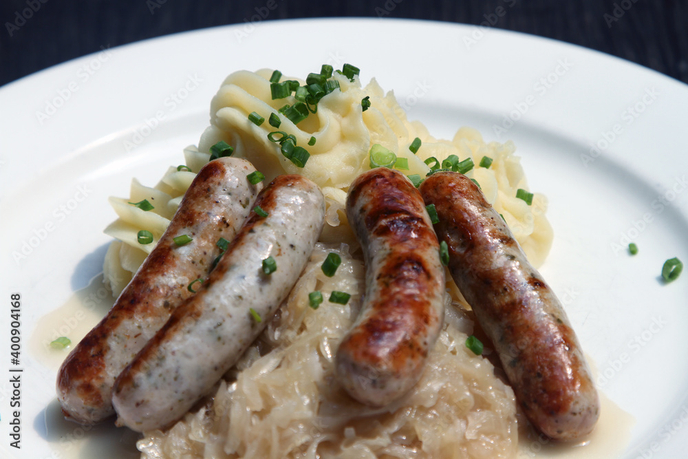Nuremberg sausages on potato mash and sauerkraut